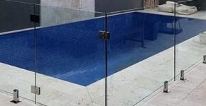 Elegant swimming pool glass fence in Dubai providing clear safety barrier around a modern pool.