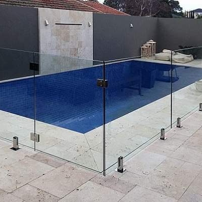 Elegant swimming pool glass fence in Dubai providing clear safety barrier around a modern pool.