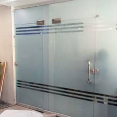 Custom logo design on glass using frosted paper installation in Dubai