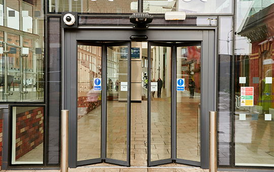 Modern glass bifolding sensor doors in Dubai installed at a luxury villa entrance